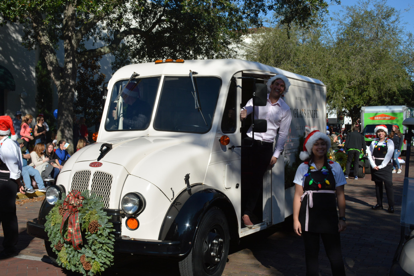 The Glass Knife truck with driver popping out and smiling. Woman in apron smiling as well