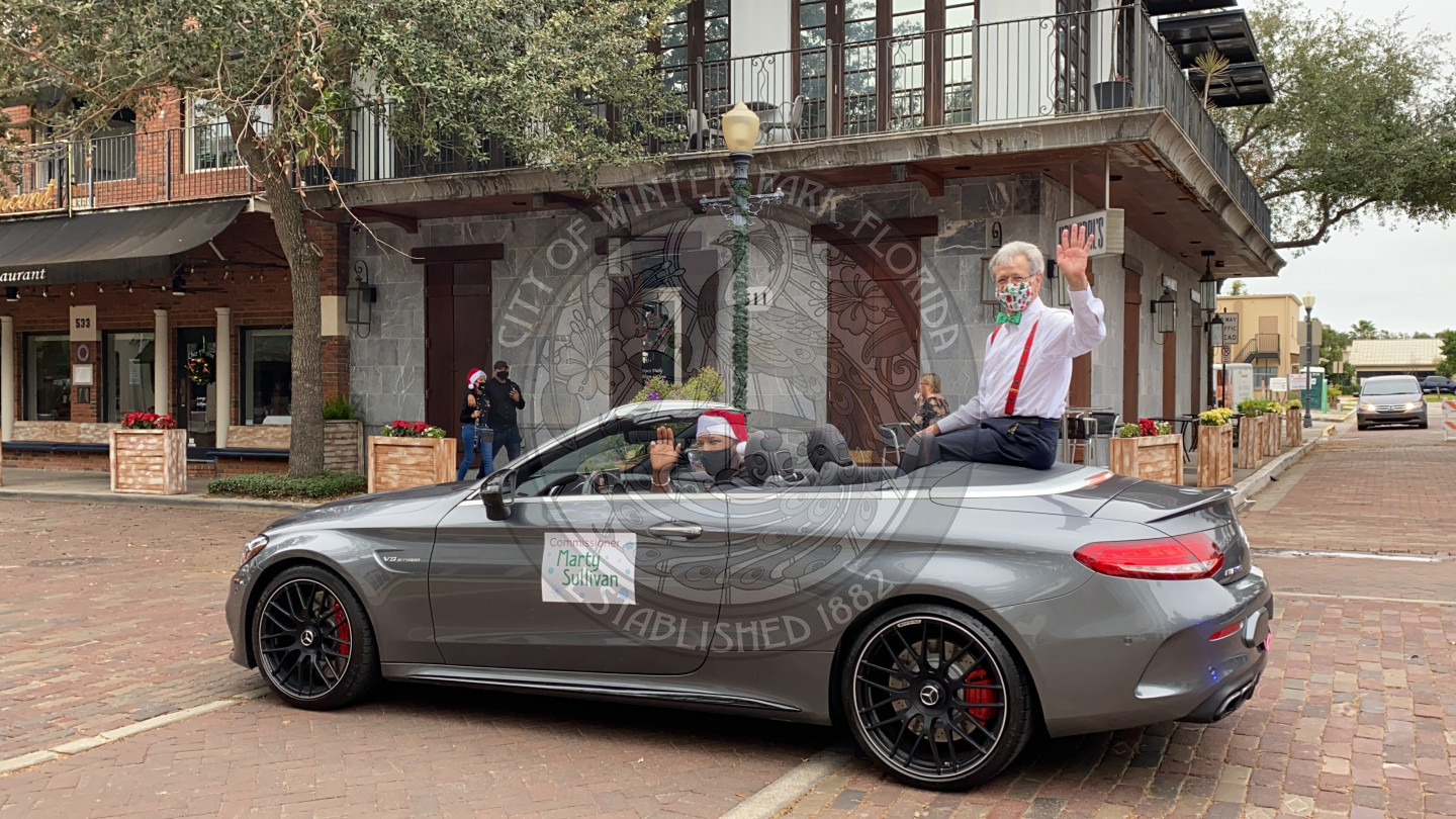 Commissioner Sullivan waving from his parade car