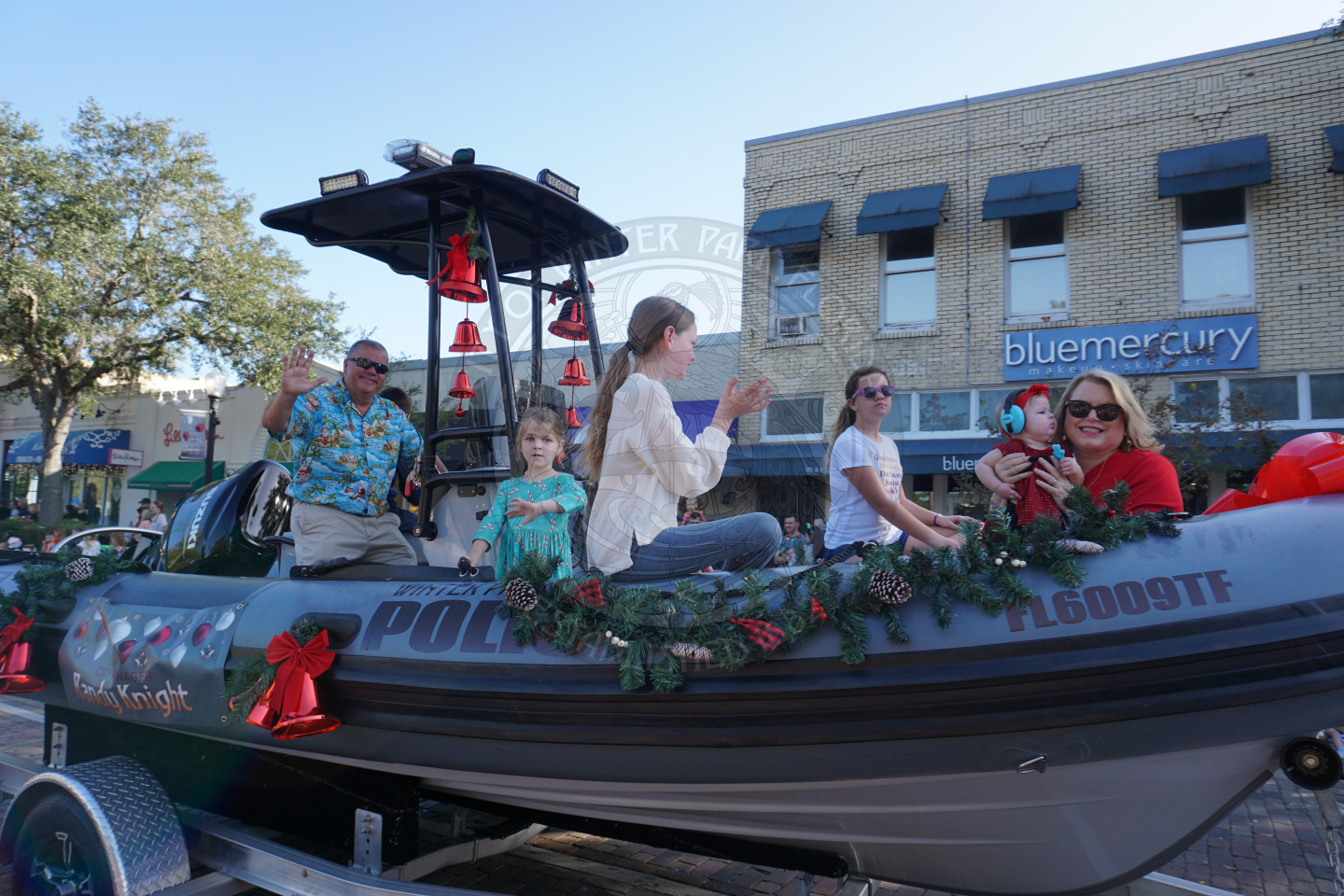 City Manager Randy Knight and his family sitting on a boat smiling.
