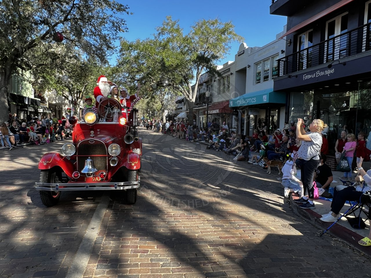 Mr. and Mrs. Claus driving down Park Avenue