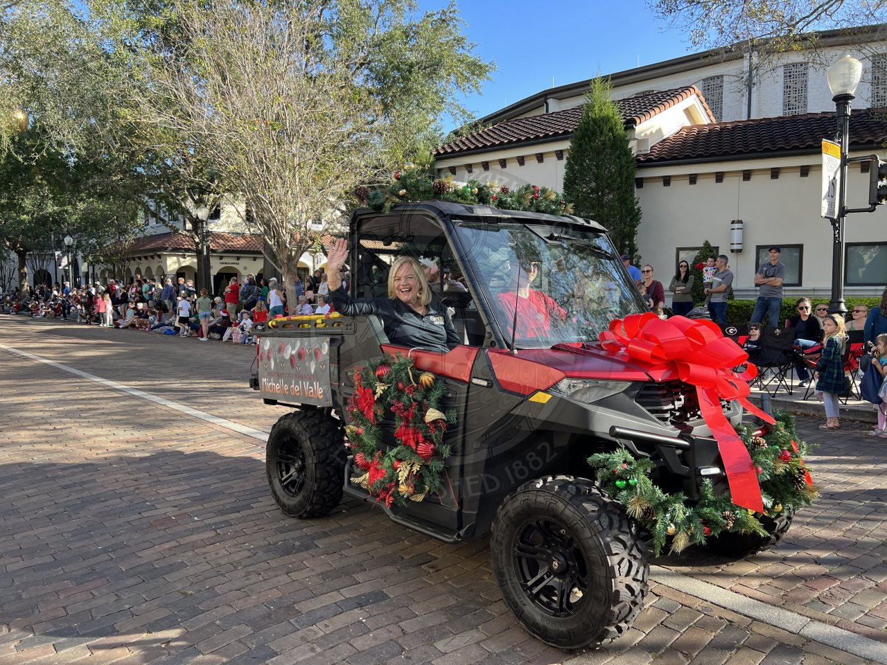 Assistant City Manager riding in an ATV and waving at the camera