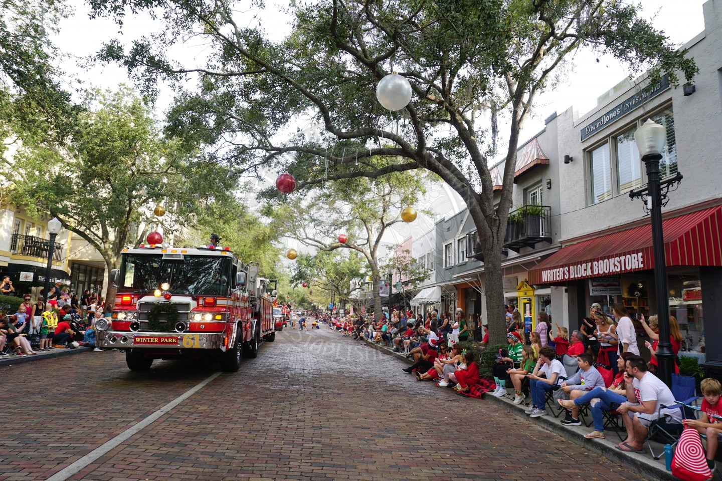 a scenic view of Park Avenue with a firetruck driving down the road for the Chrismtas Parade.