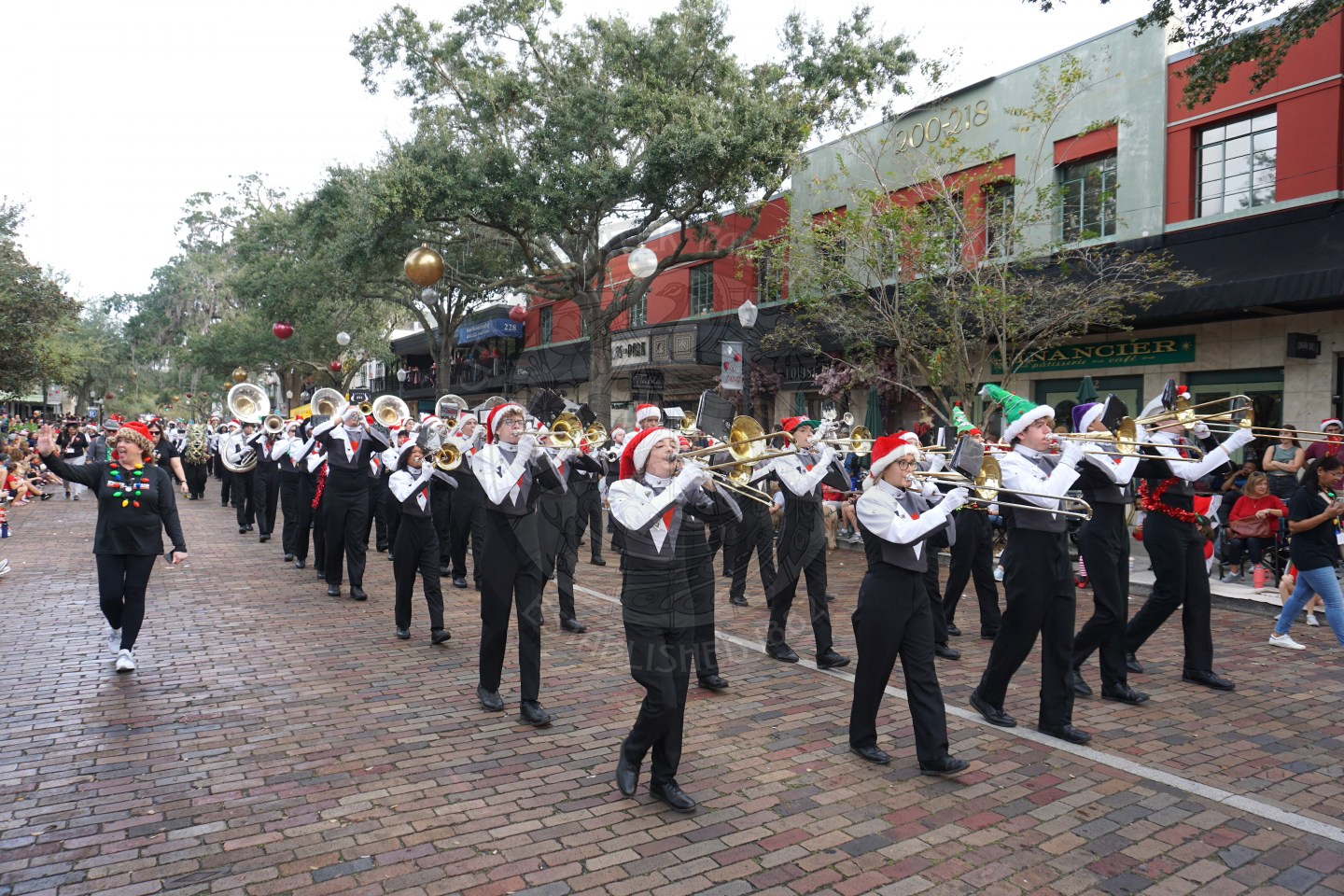 Winter Park High School band marching down Park Avenue playing their instruments.