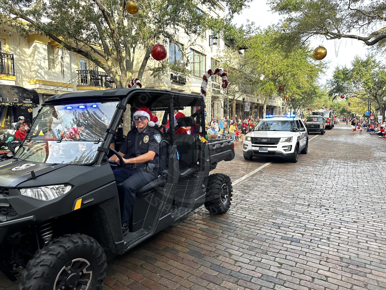 Winter Park Police Chief Tim Volkerson driving an all terrain vehicle smiling.