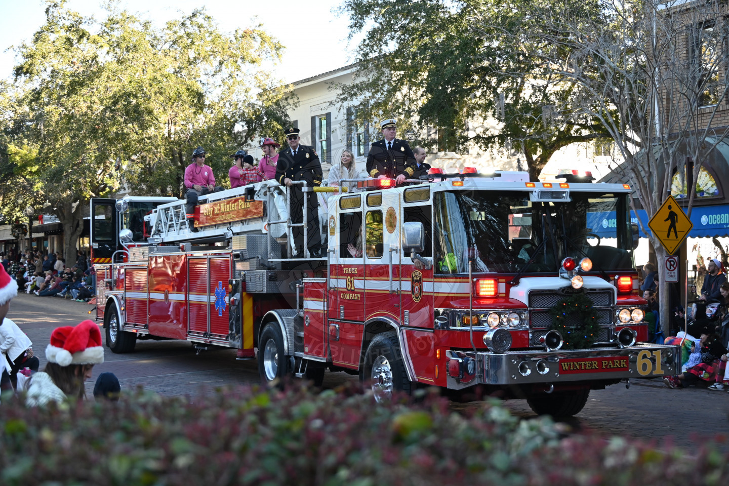 firetruck with firemen sitting on the top.