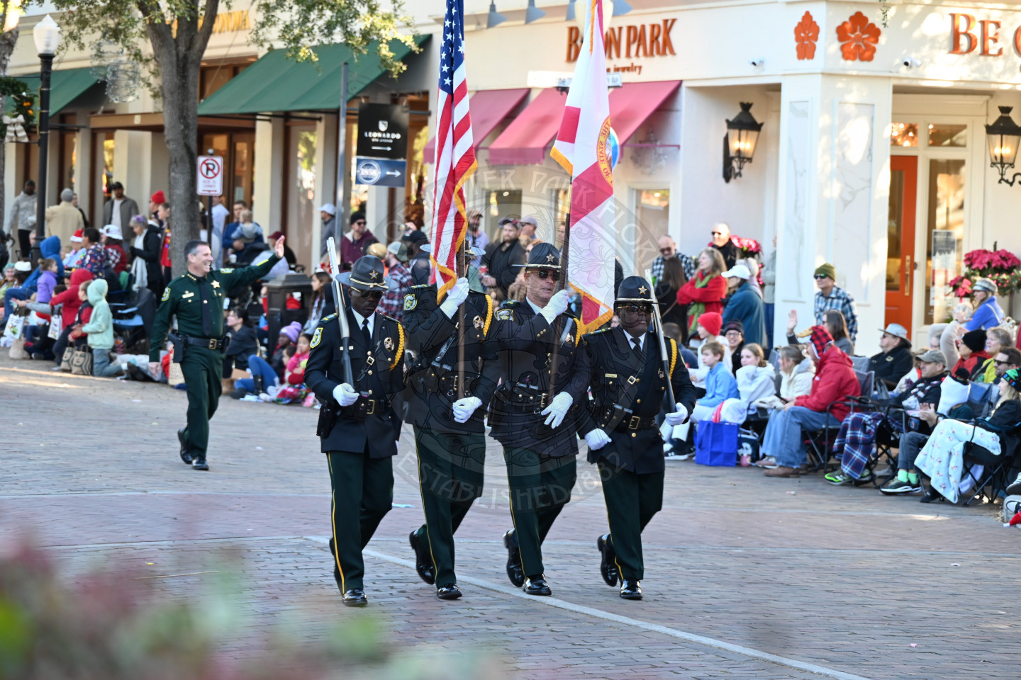 officers presenting colors walking down the avenue.