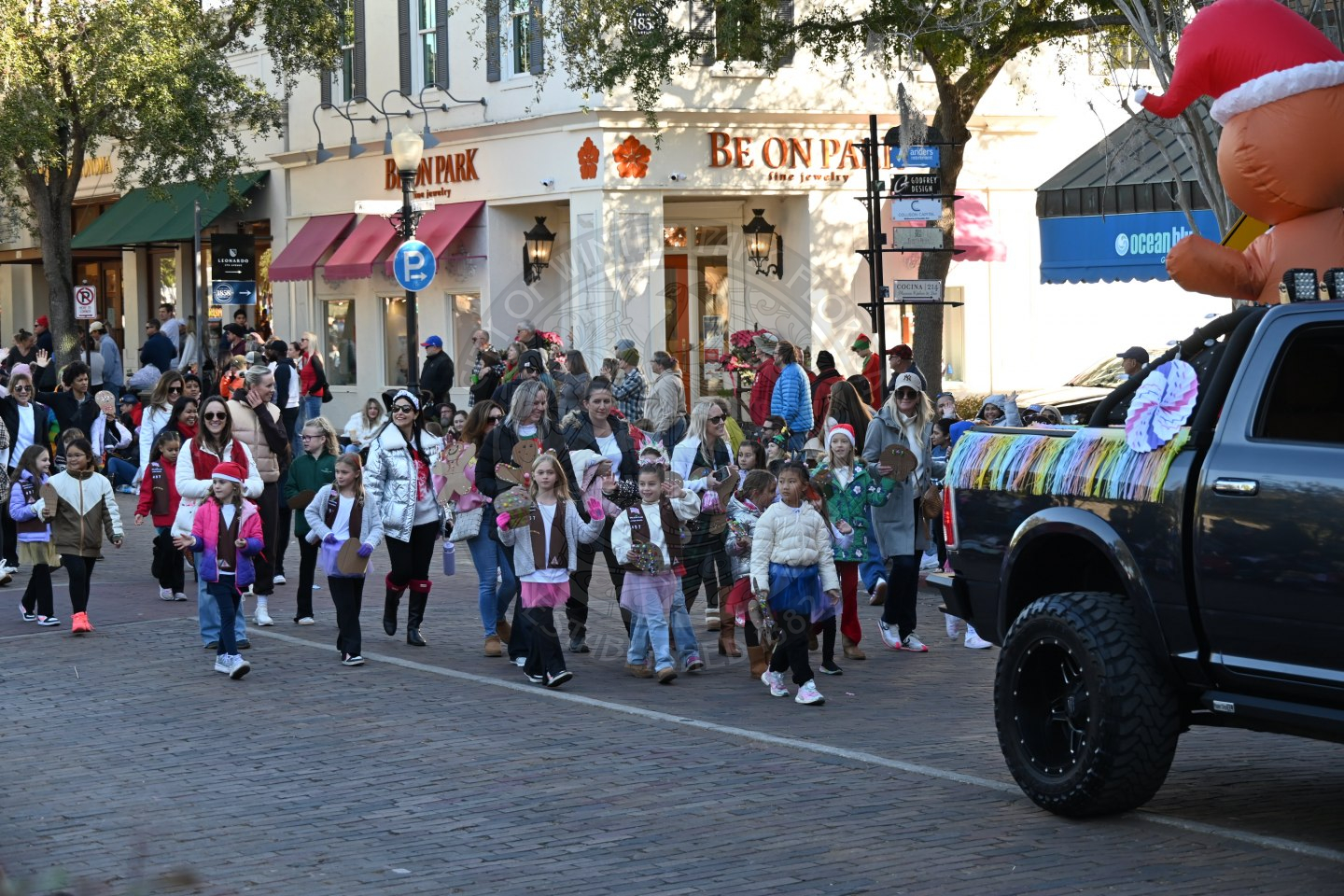 Girl scouts wlaking down park avenue smiling and waving.