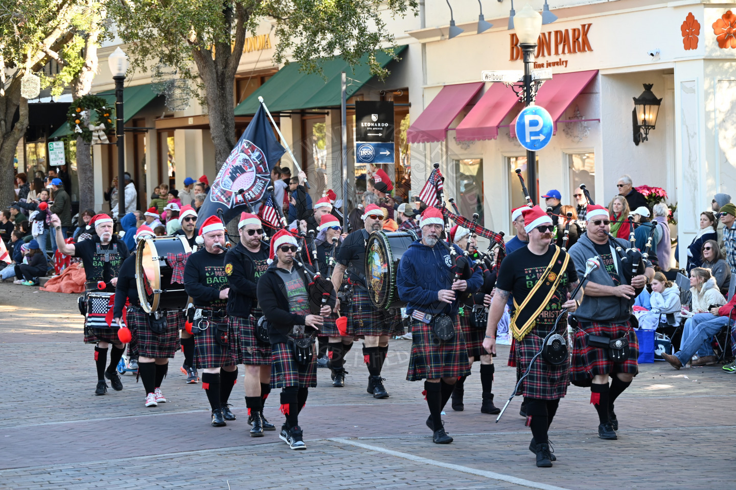 bagpipe group walking down park avenue playing their bagpipes.