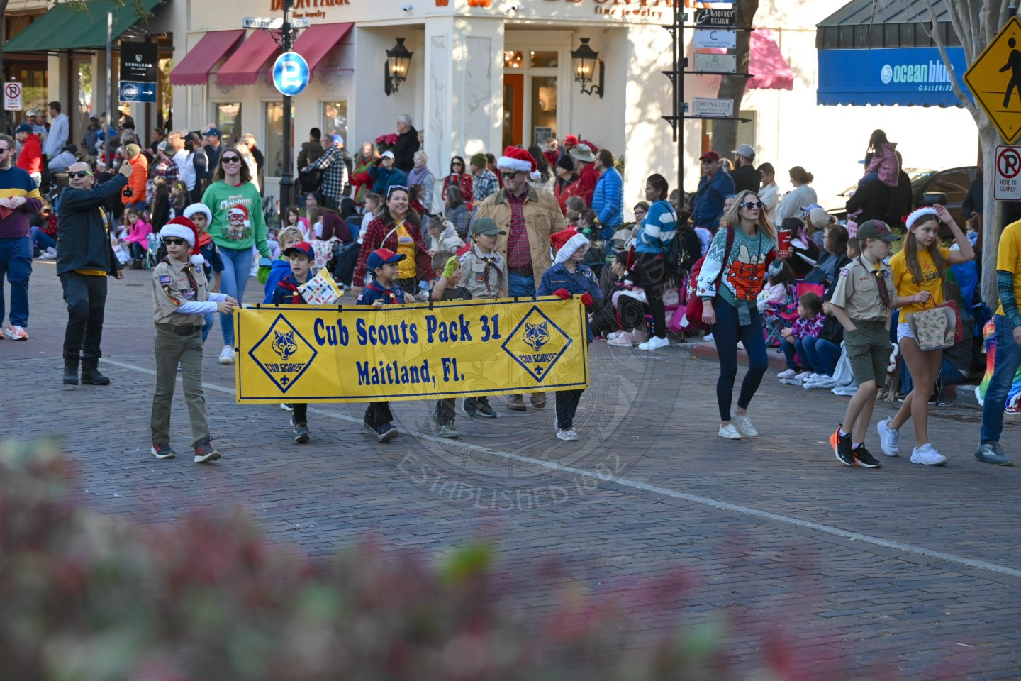 Cub scout pack 31 walking down park avenue wearing their uniforms.