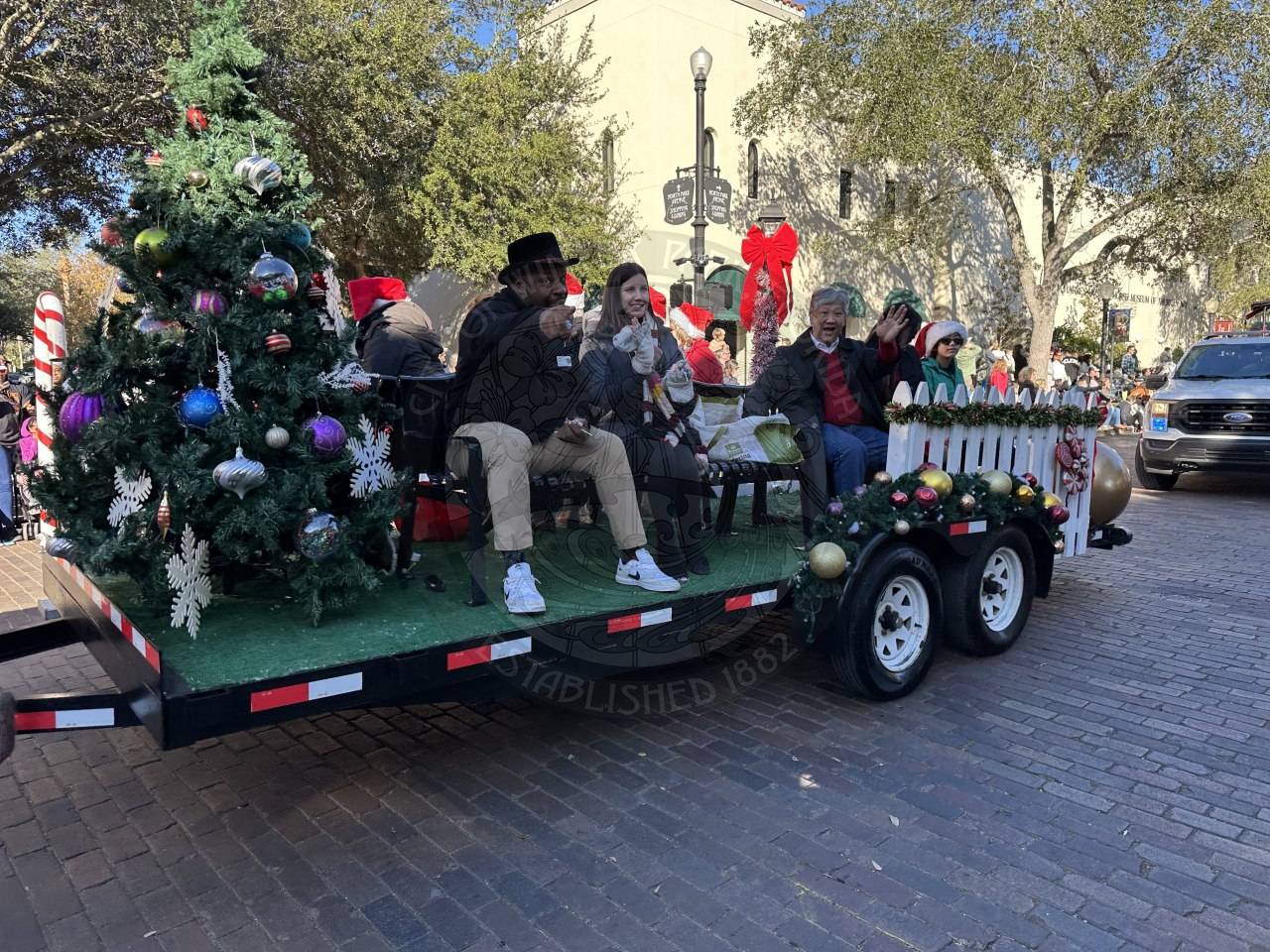 Commissioner Russell and Commissioner Cruzada smiling and waving at the crowd watching the parade