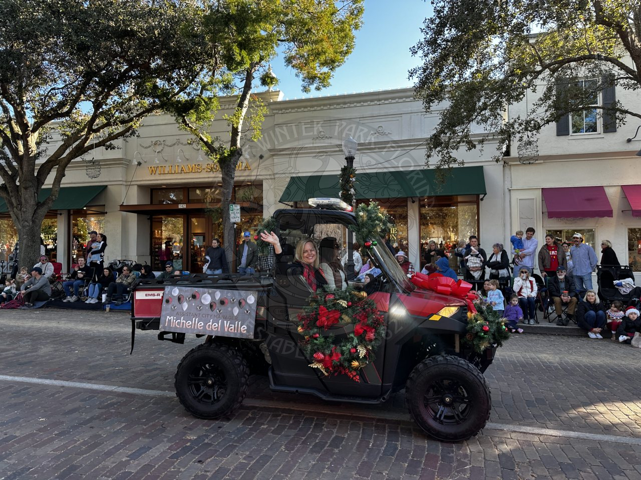 Assistant city manager in a golf cart waving.