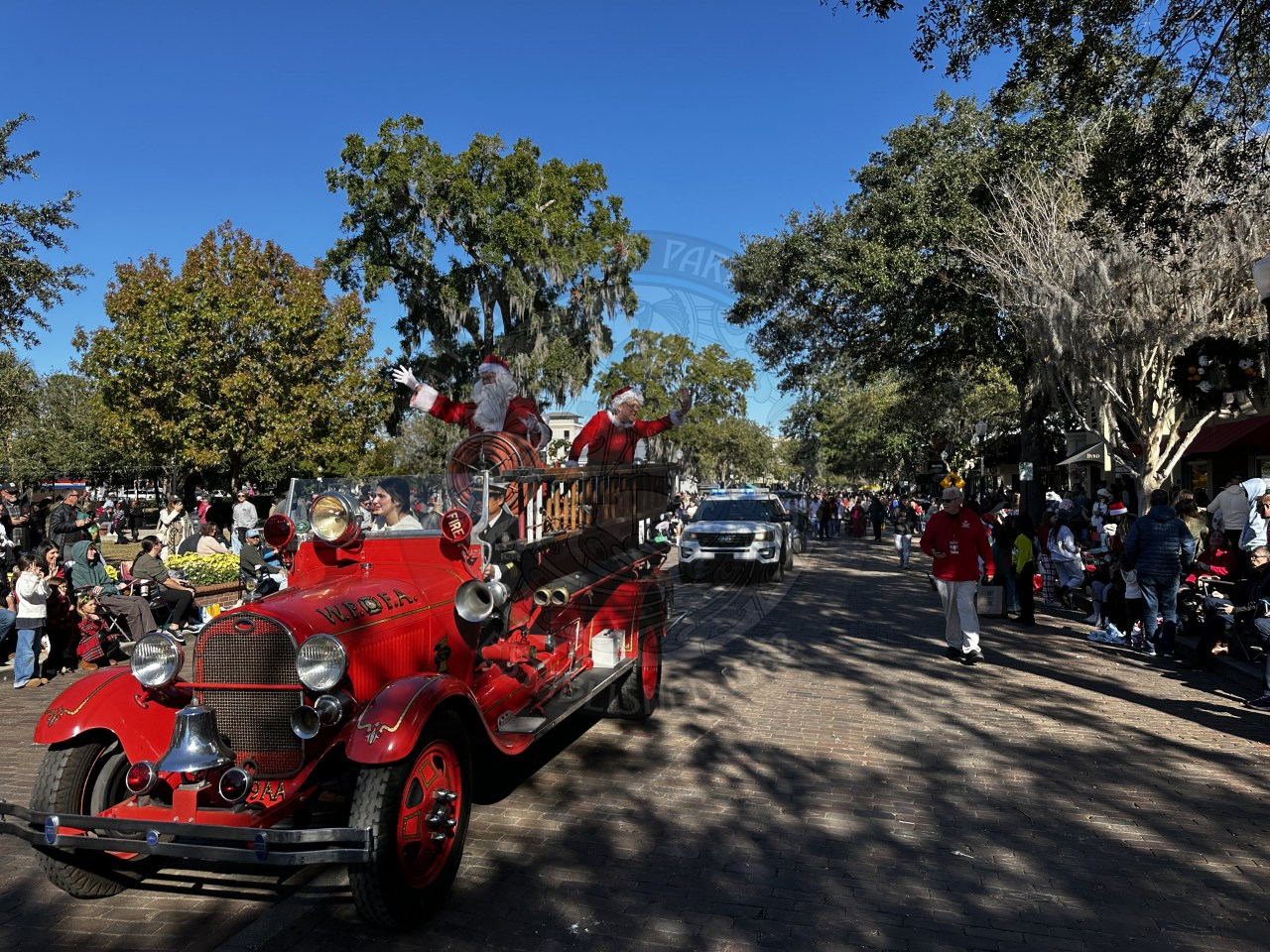 Santa and Mrs. Claus waving to the kids on the parade route.