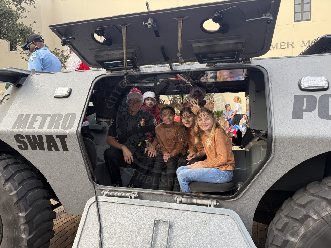Police Chief with kids riding in the Metro Swat Police vehicle.