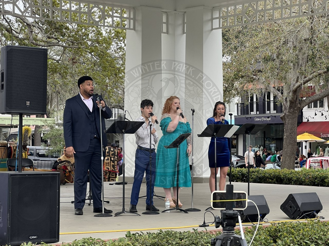 A group of people singing on stage.