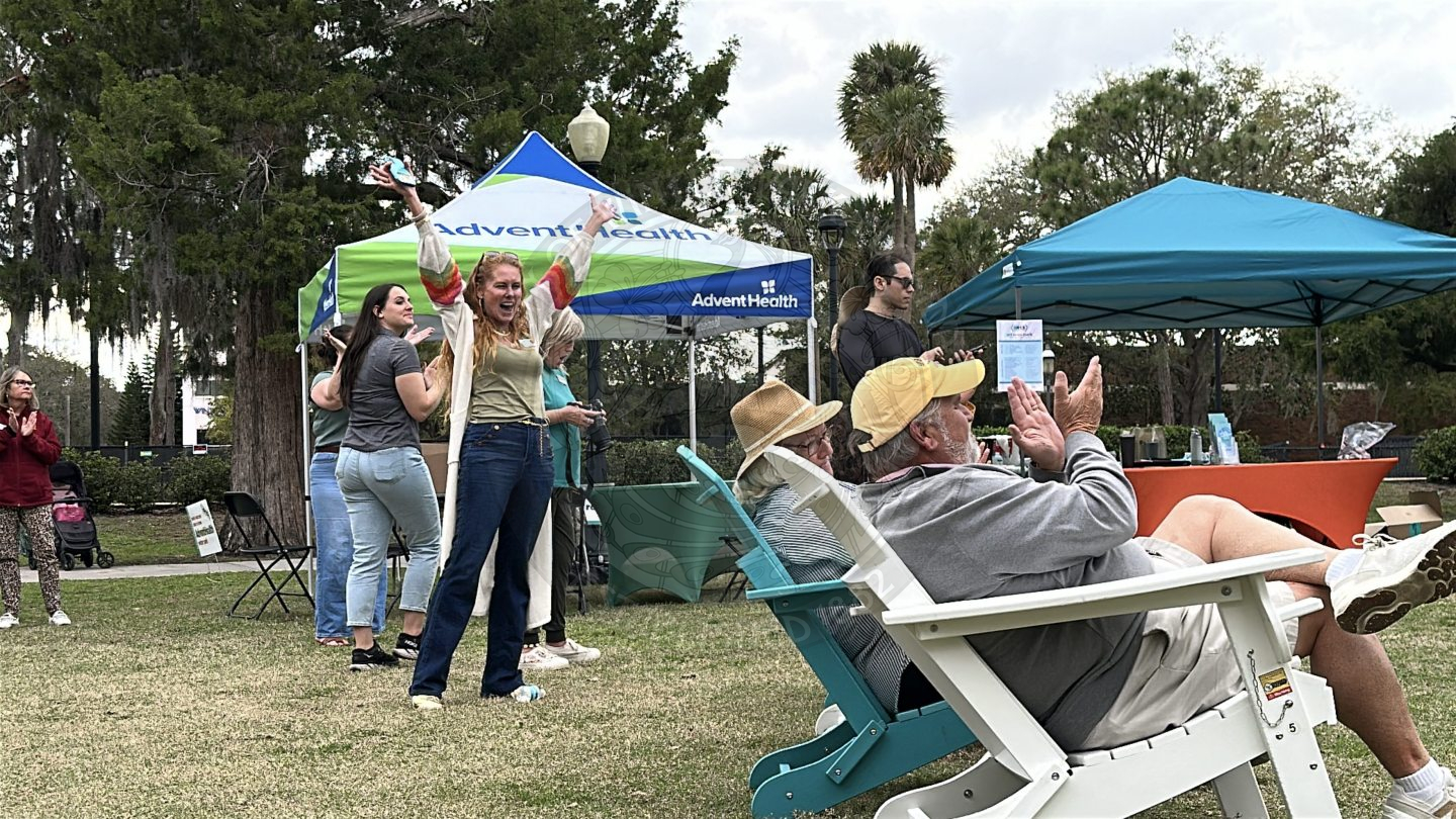 a woman putting her hands up in excitement.