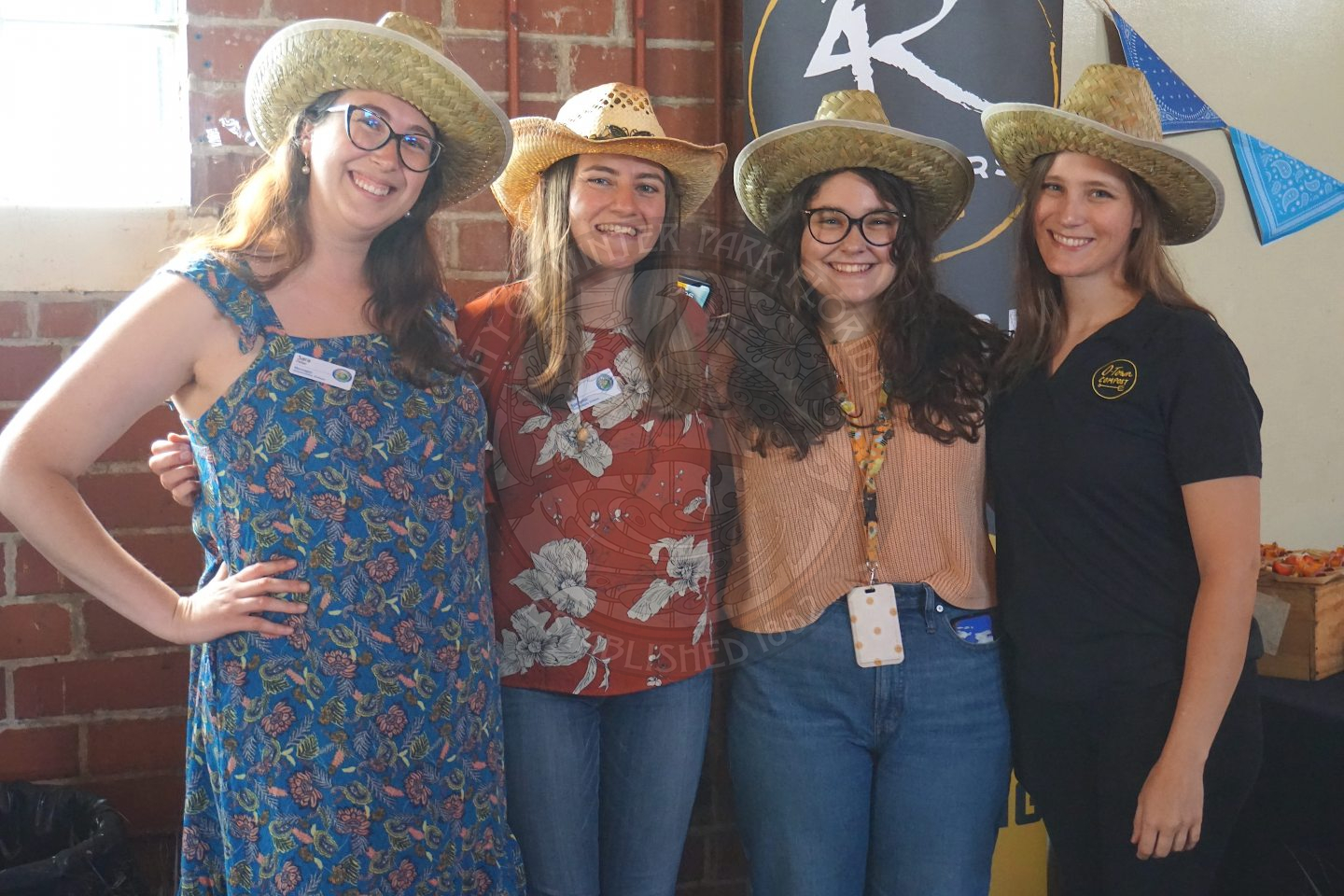4 woman standing next to each other smiling