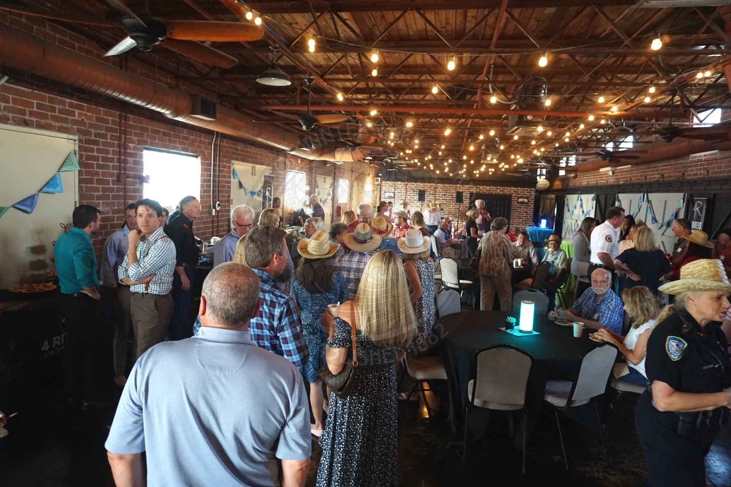 candid shot of a lot of people mingling at the farmers' market
