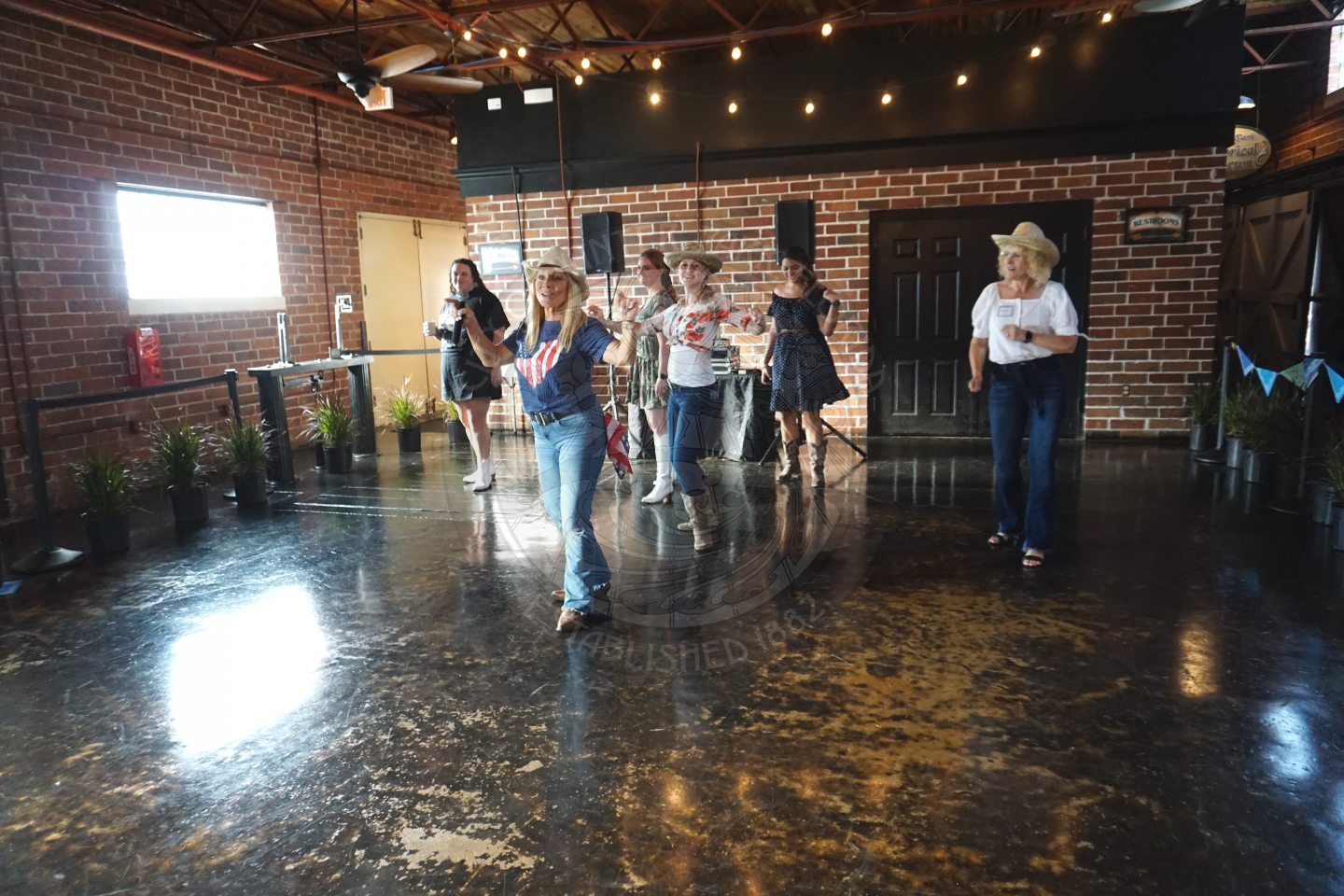 group of people learning how to line dance