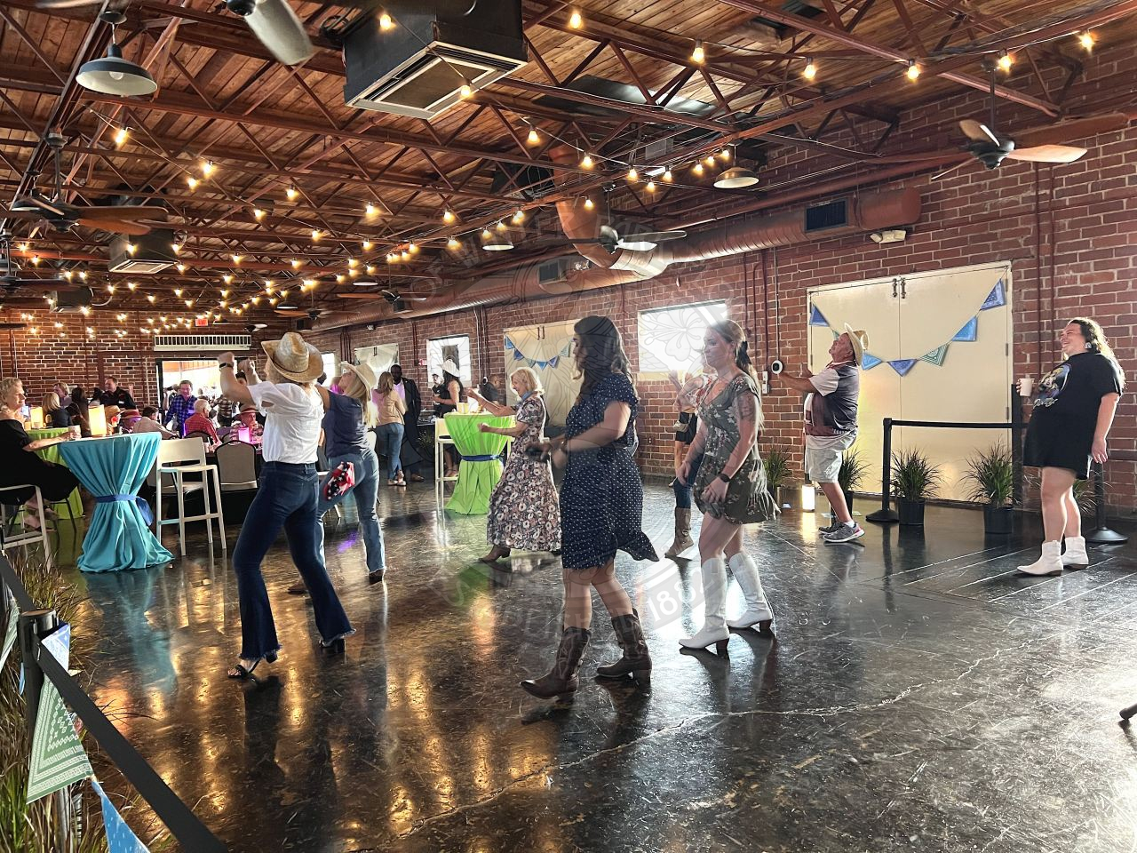 group of people line dancing on concrete dance floor