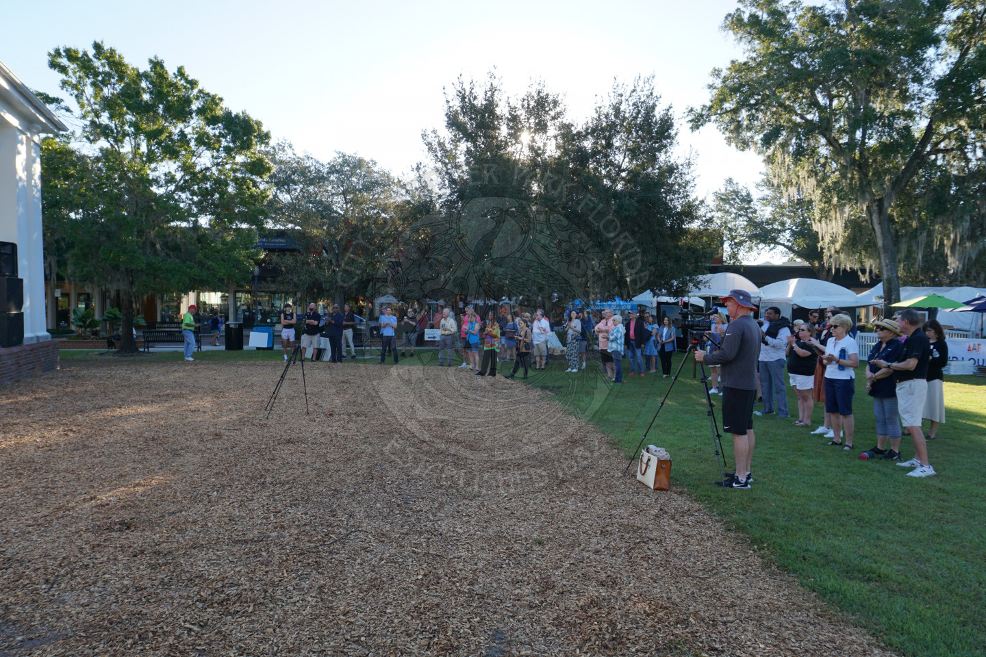 Crowd in front of the stage watching the ribbon cutting