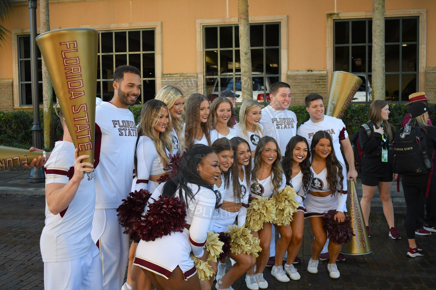 Group of male and female cheerleaders posing for a picture