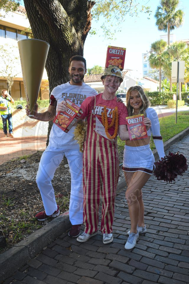 Male dressed in Cheez-It gear posing with the FSU cheerleaders