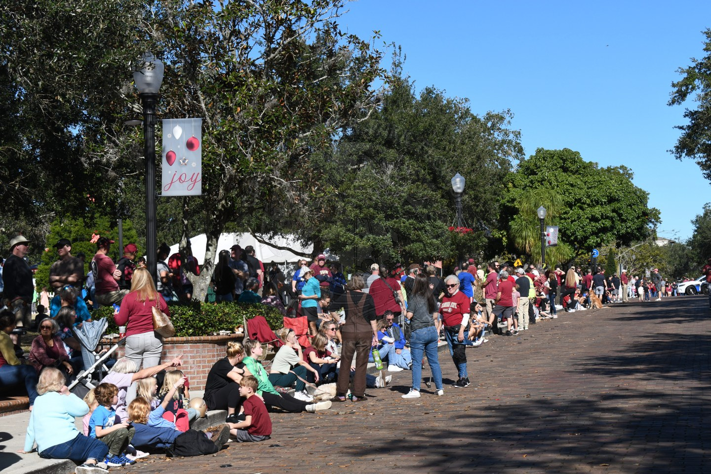 Park Avenue sidewalks filled with peple sitting and standing waiting for Parade of Bands to start
