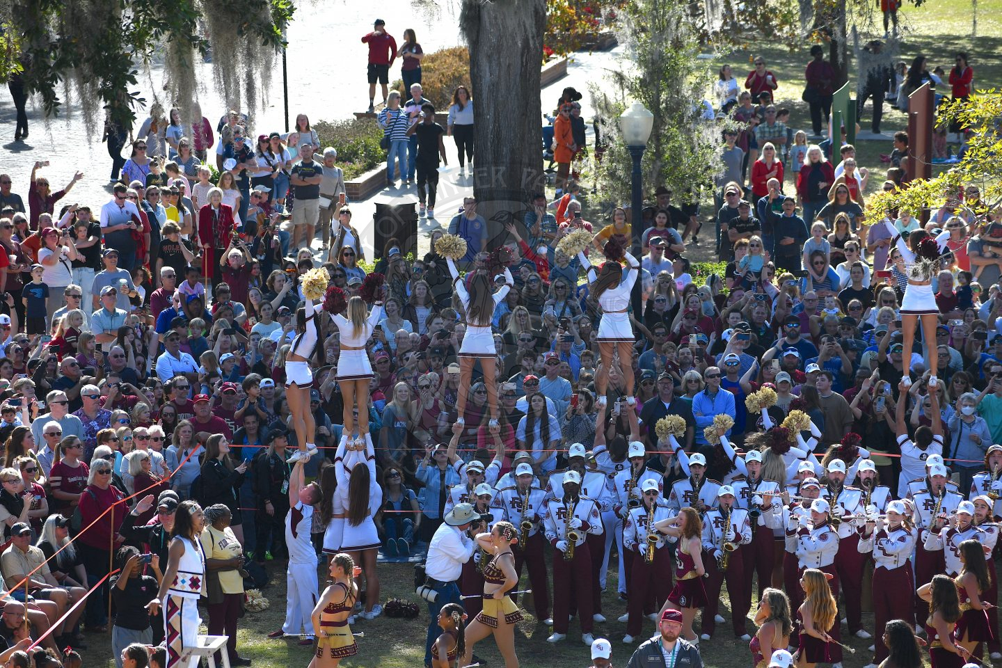 FSU Cheerleaders doing stunts while band performs