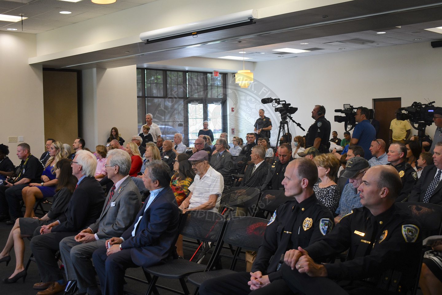 Group of people sitting down watching Chief Volkerson swearing-in