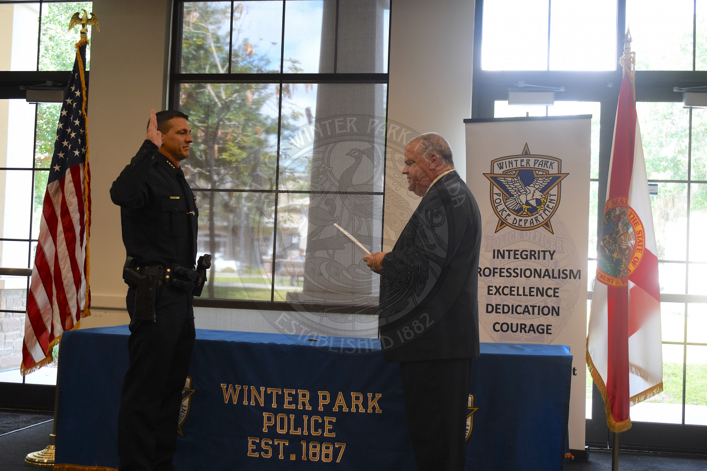 Man swearing in another man as the Chief of Police