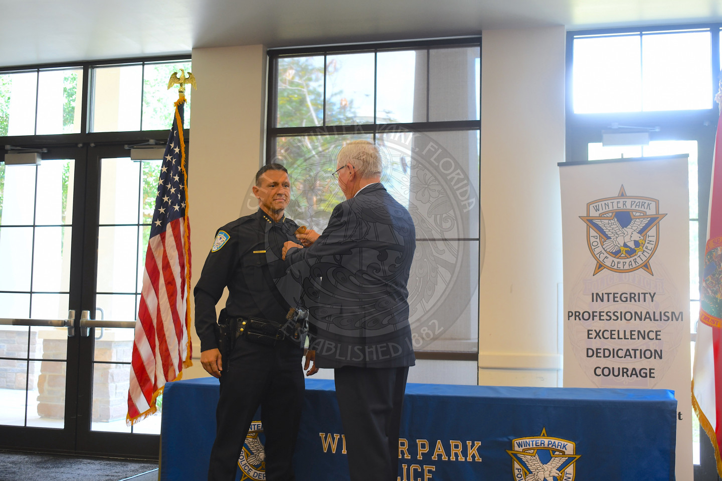 A man pinning Chief Volkerson