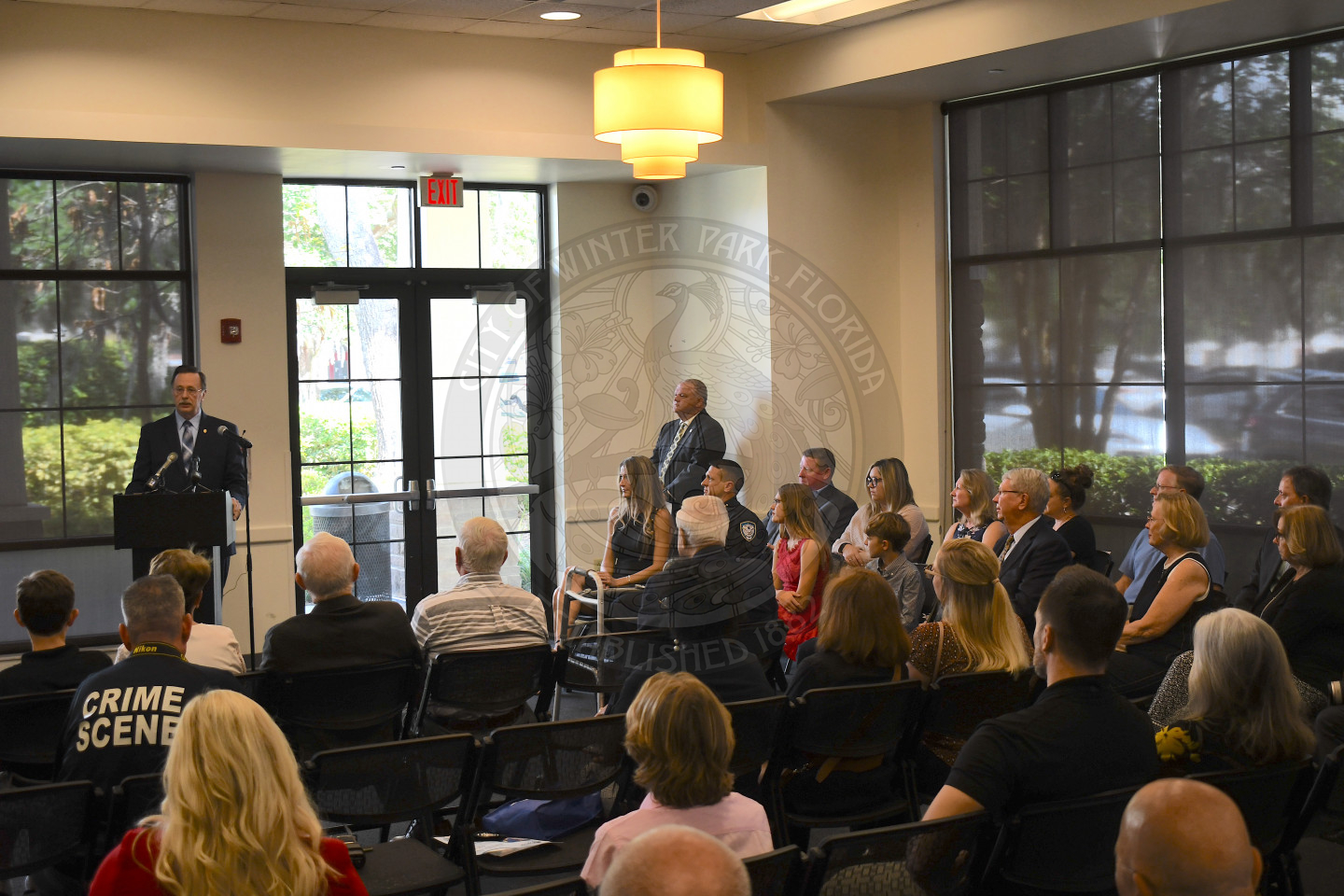 Man talking to audience about Chief Volkerson