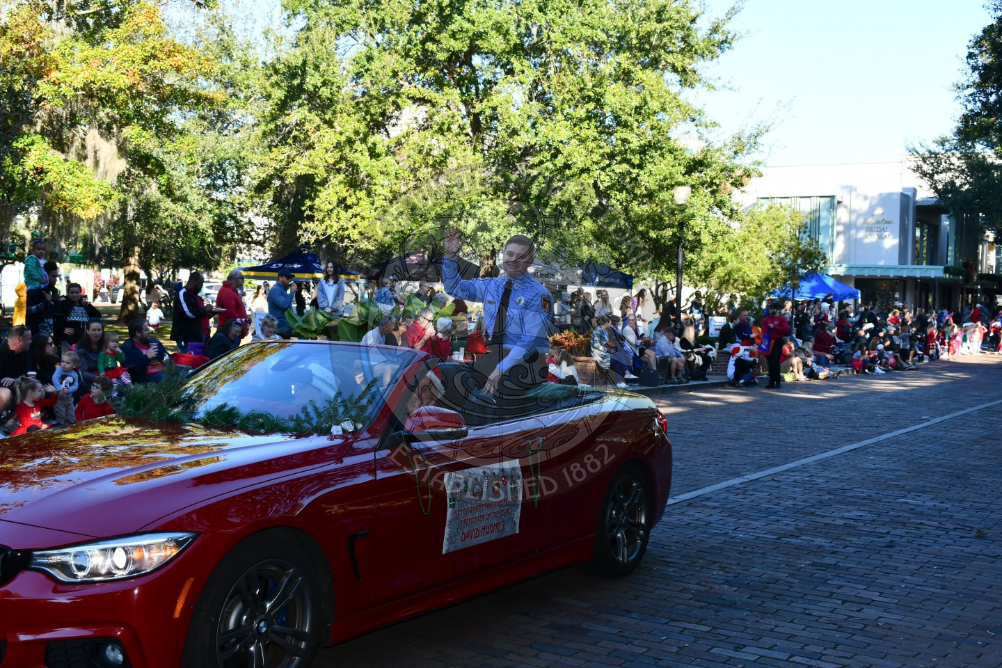 Winter Park Firefighter of the Year sitting in the convertible waving to the crowd