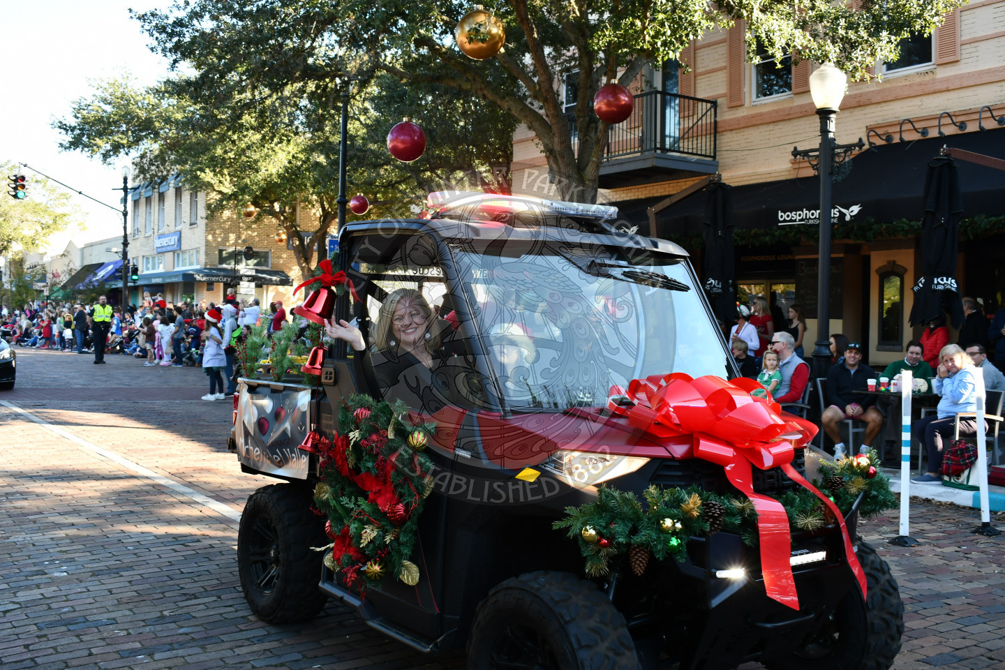 Assistant City Manager waving to the camera while riding by on an ATV