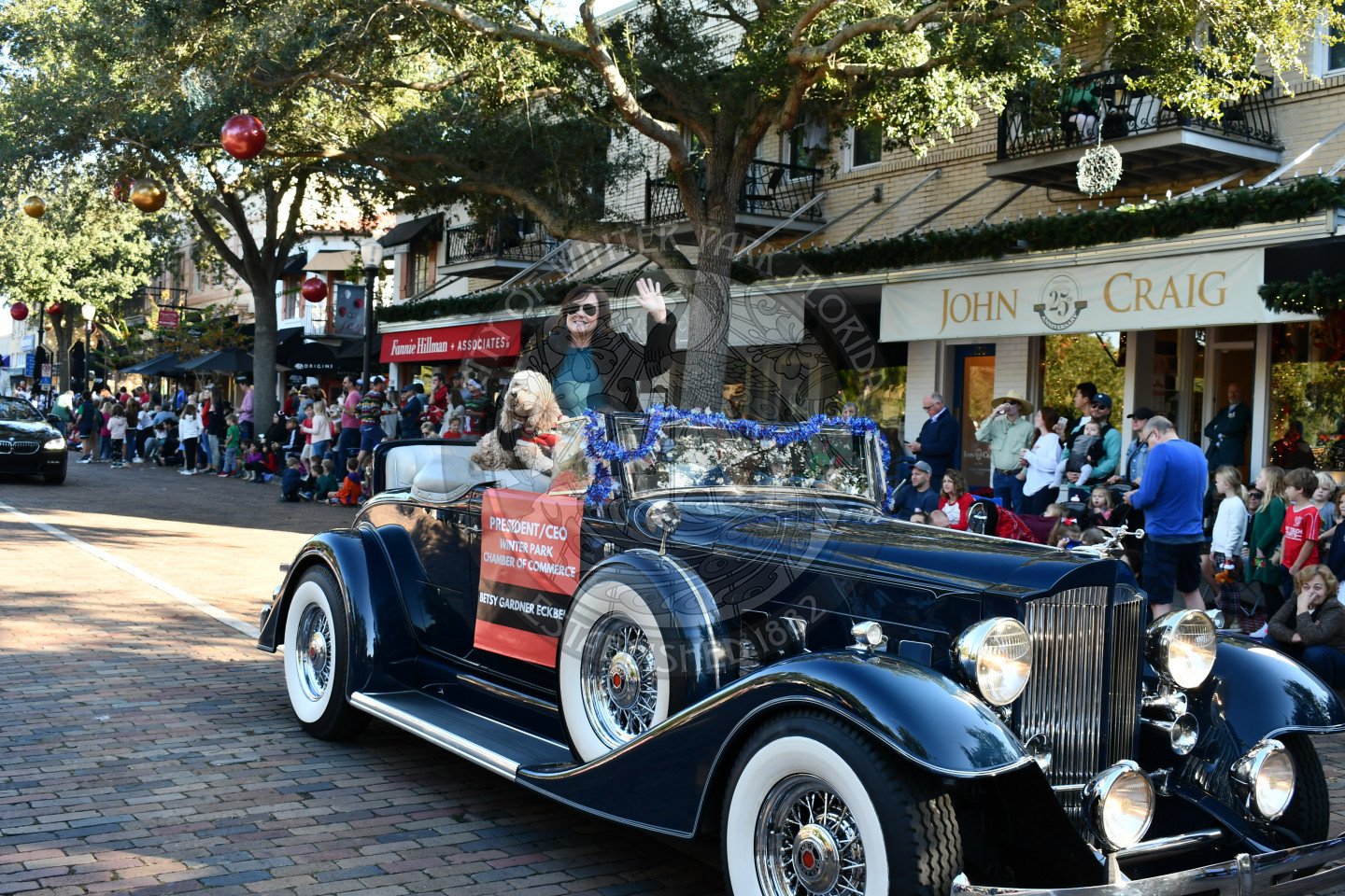 Winter Park Chamber of Commerce CEO sitting in a car waving to the crowd