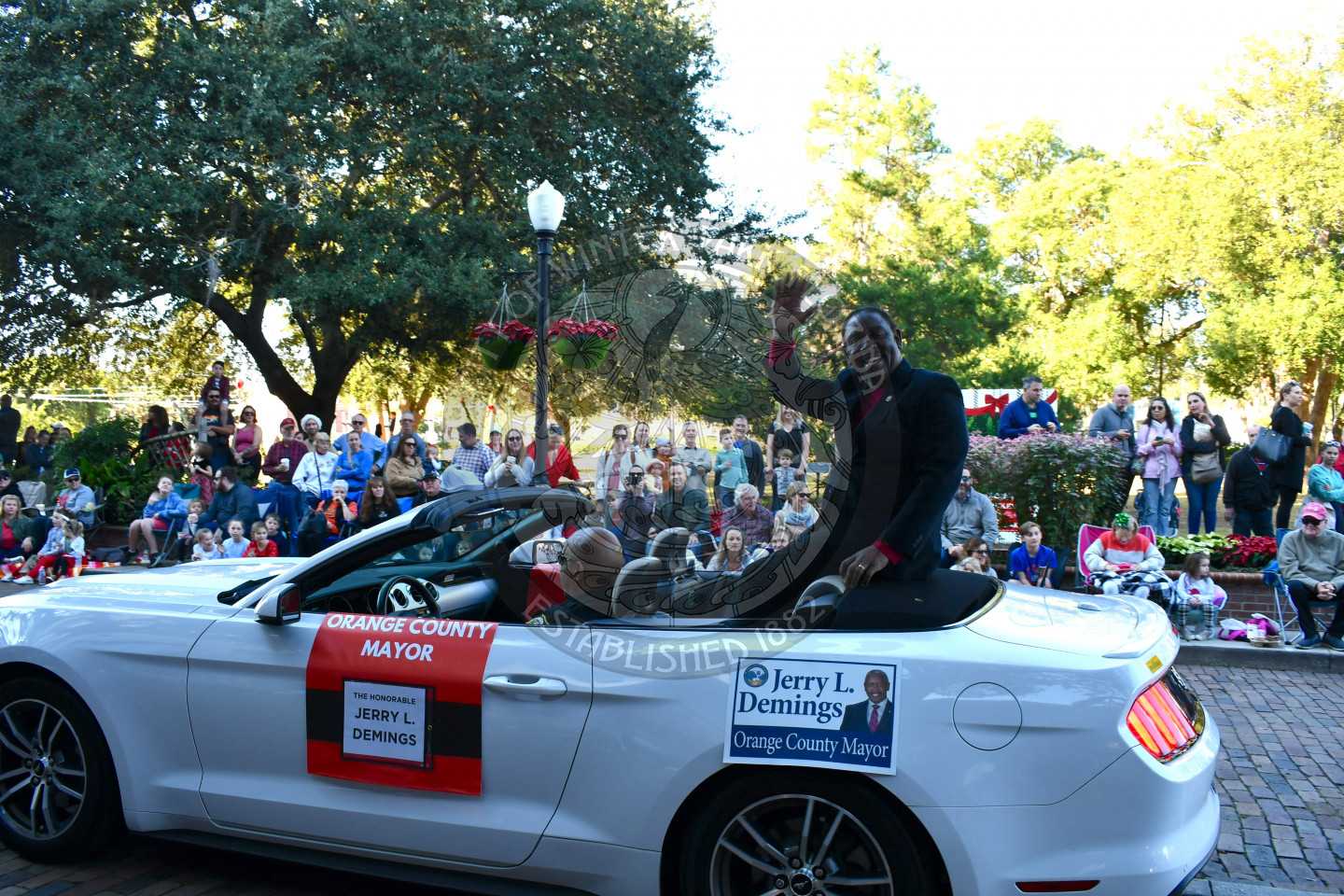 Orange County Mayor sitting in car waving to the crowd