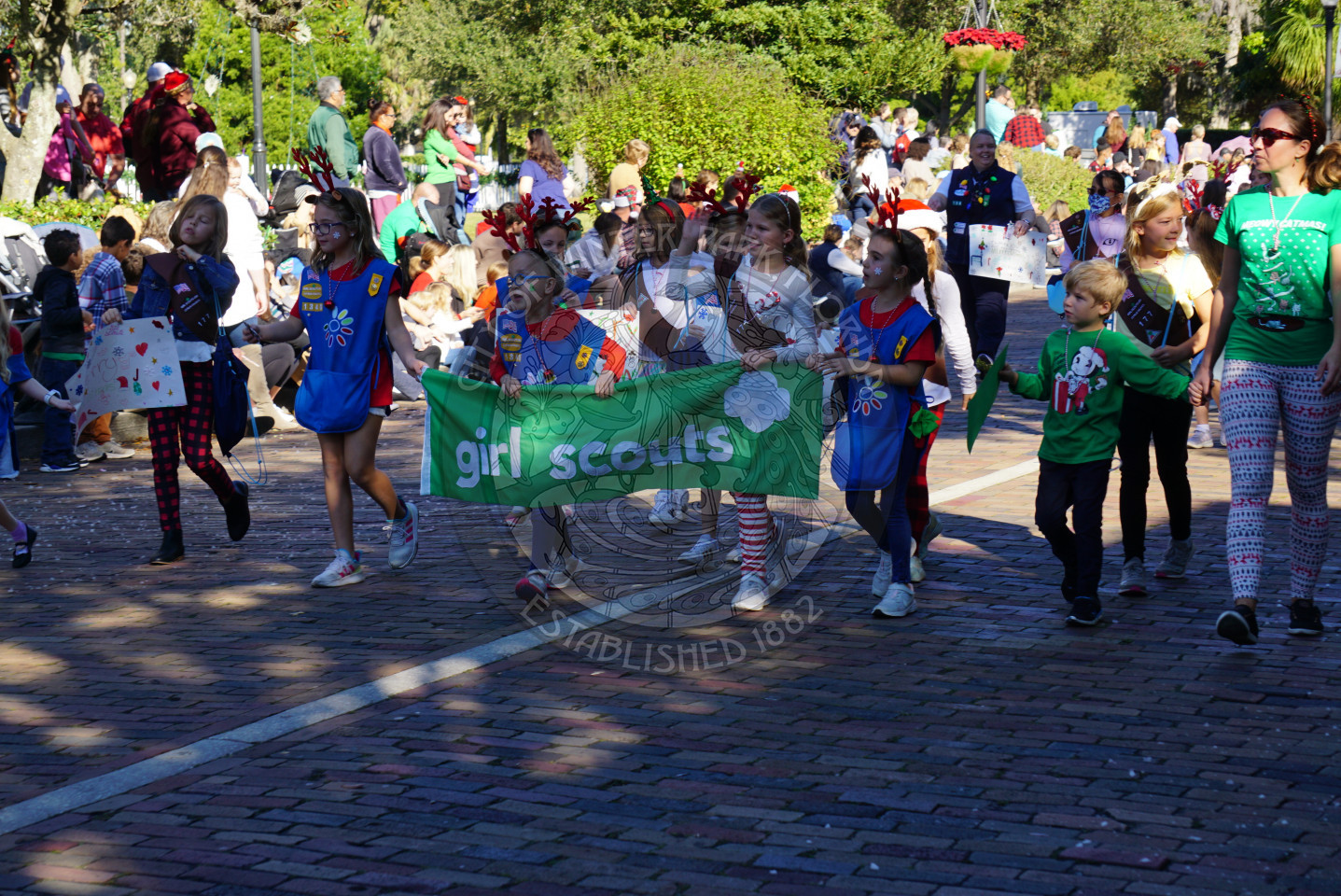 Girl Scouts walking through Christmas parade route