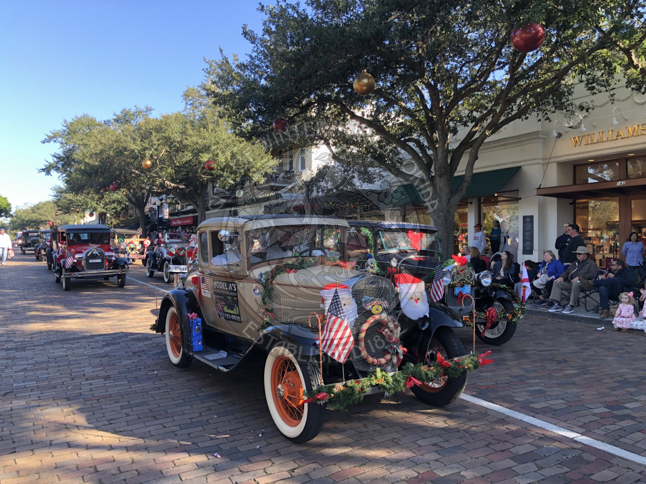 Old school cars driving in the parade route