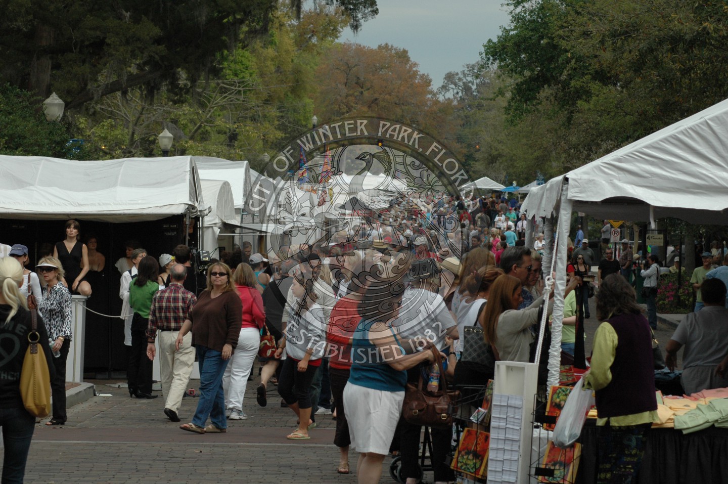 Photo of art festival with tents lining both sides of  Park Avenue filled with attendees
