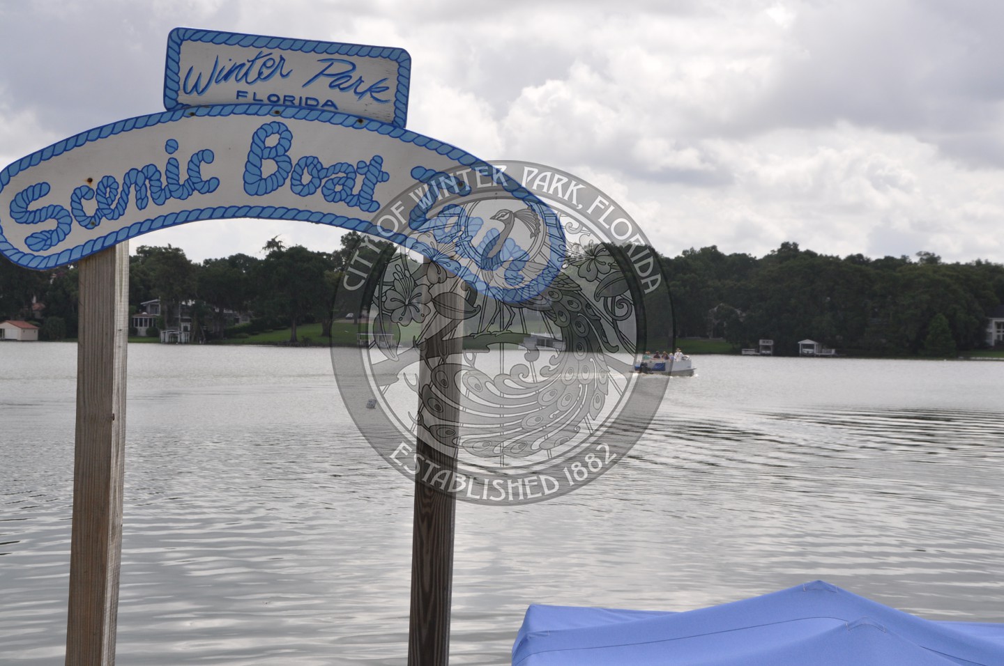 Scenic Boat Tour signage in front of the lake