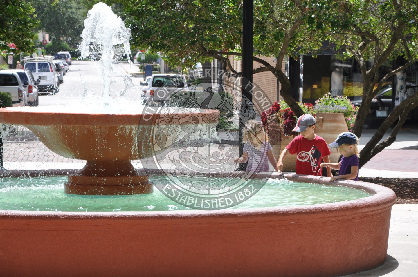 three children standing by the Veterans Fountain in Central Park
