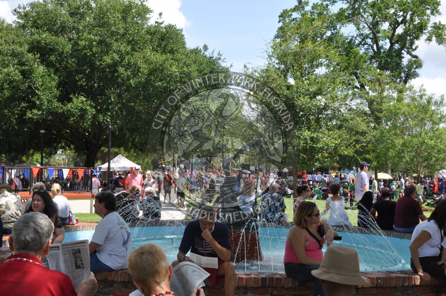 event attendees seated around the Emily Fountain in Central Park