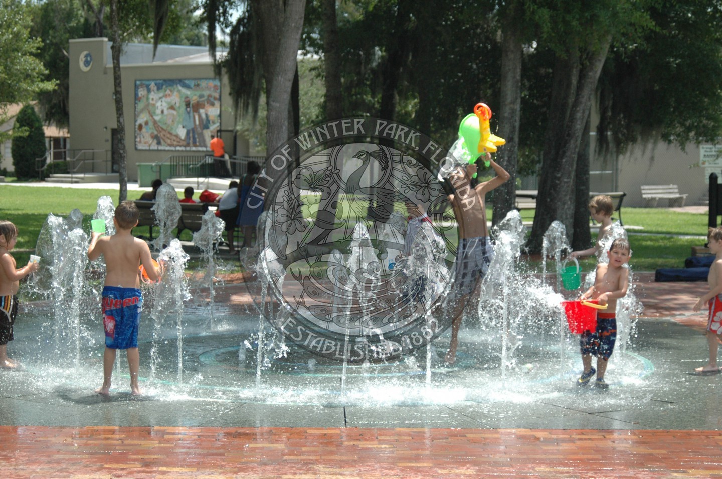 children playing in the spray fountain