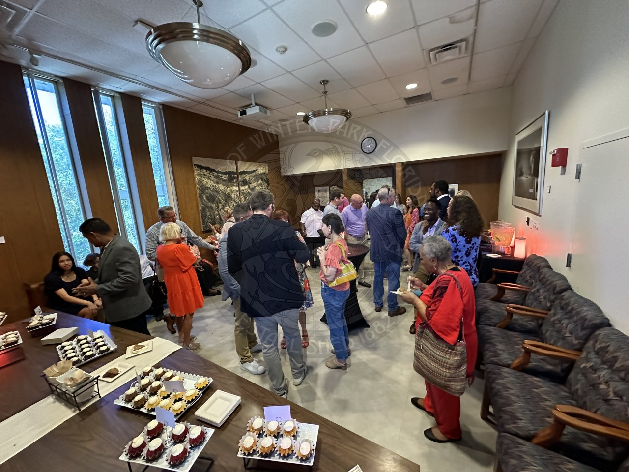 overview of the a room filled with people gathering and celerbating Commissioner Russell.