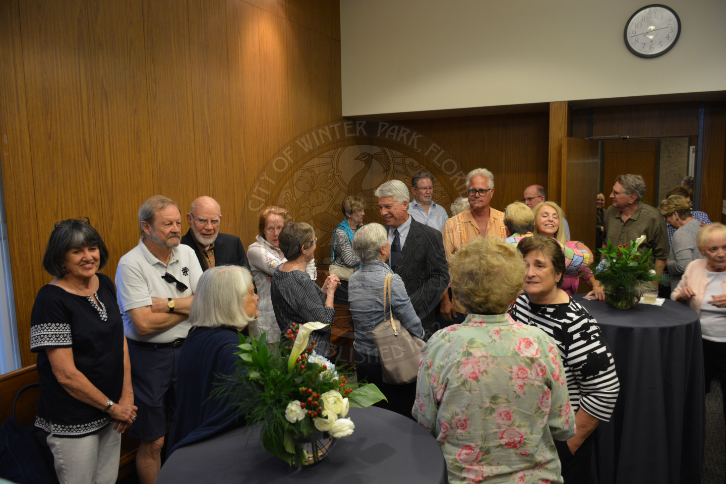 Event attendees socializing and talking with each other before ceremony begins.