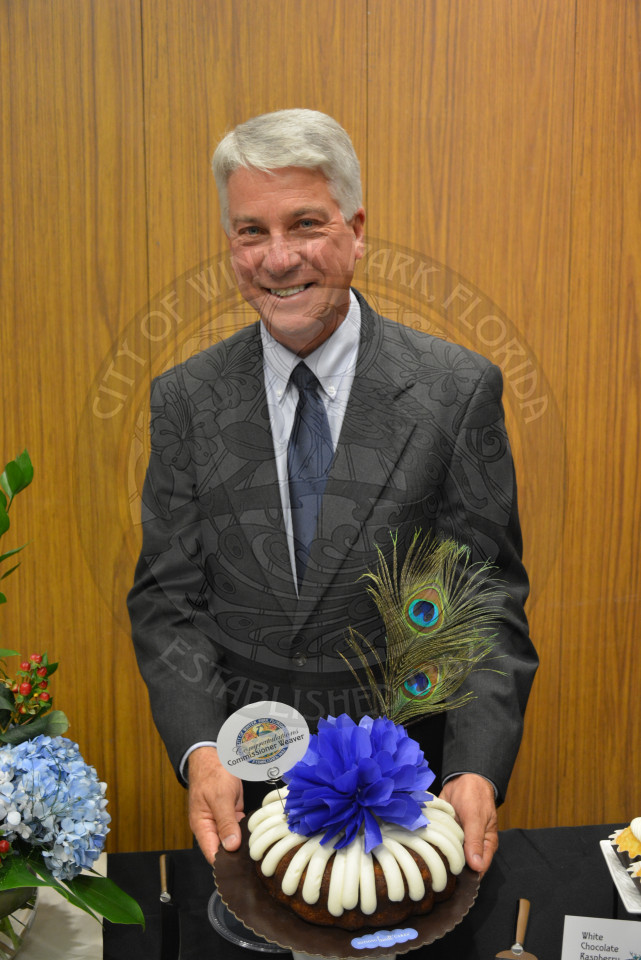 Commissioner Todd Weaver poses behind personalized congratulatory cake