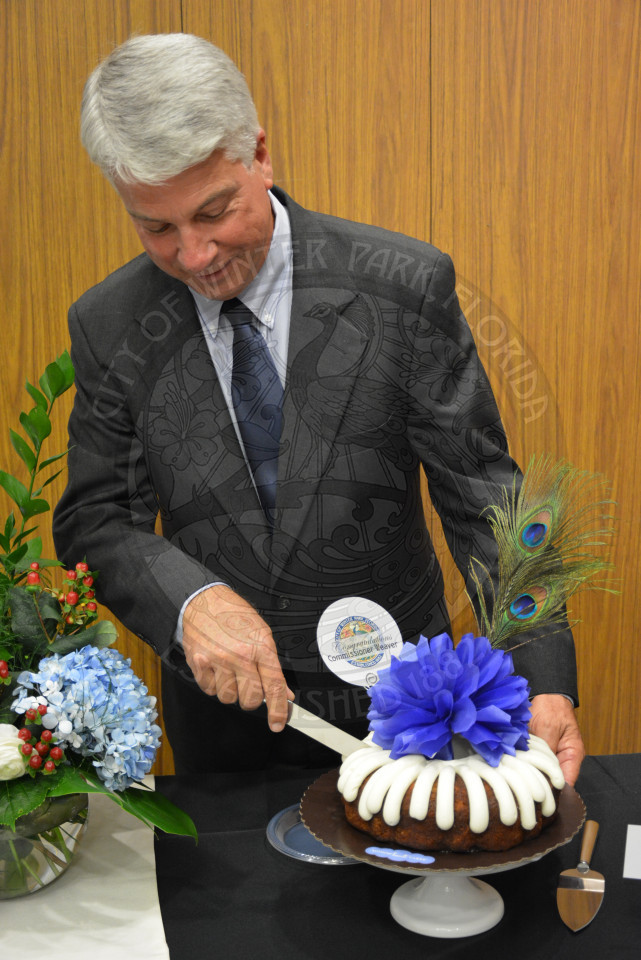 Commissioner Todd Weaver makes the first cut into the cake