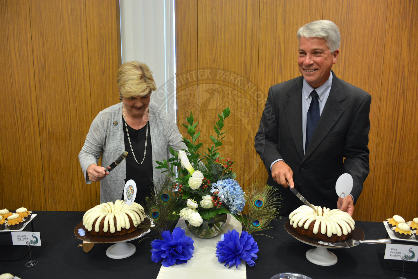 Commissioners Carolyn Cooper and Todd Weaver cutting their cake with big smiles