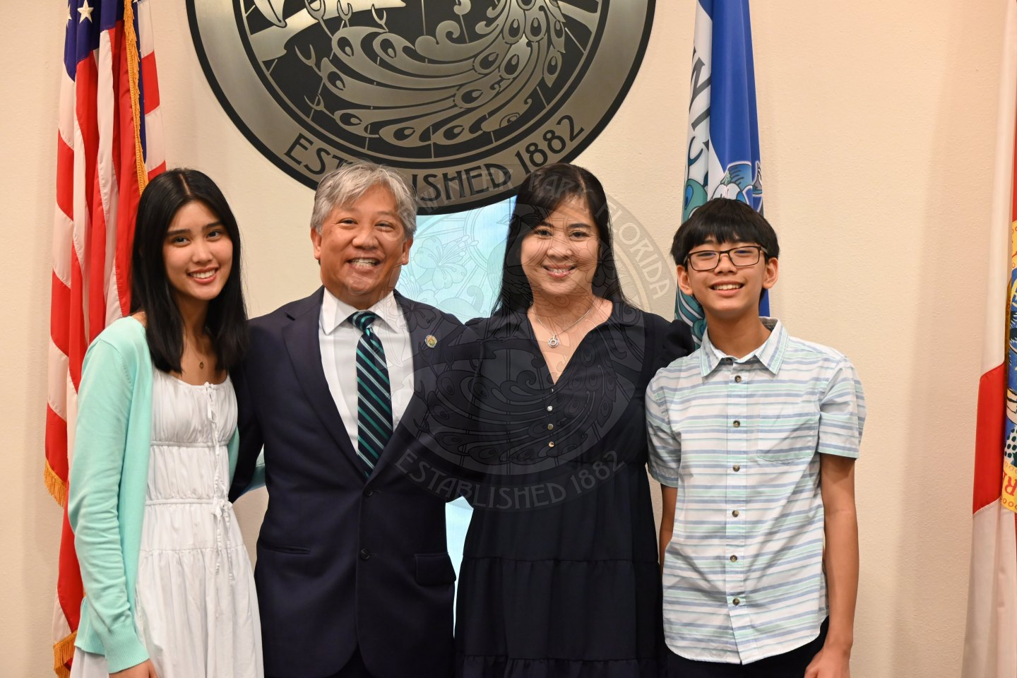 two men and two women standing next to each other smiling.