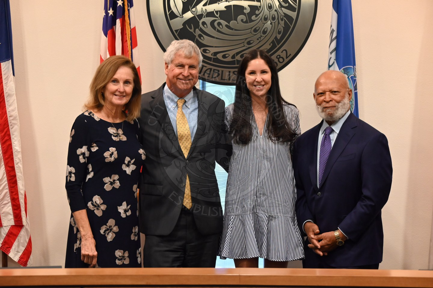 two men and two women standing next to each other smiling.